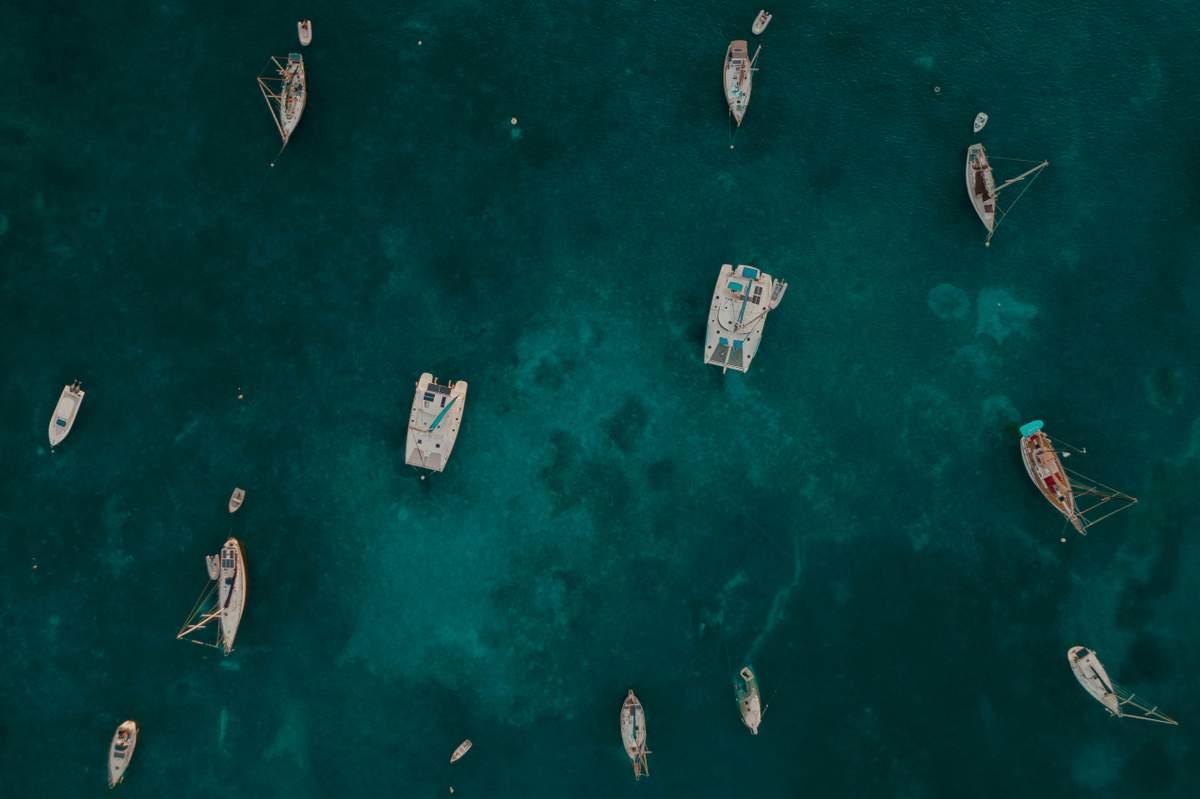Happy family with children snorkeling in crystal clear shallow waters off St. John with colorful tropical fish visible
