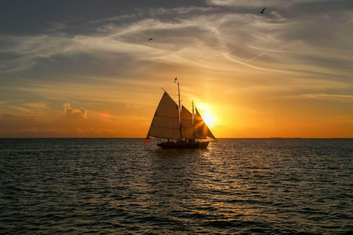 Romantic sunset cruise with silhouetted couple watching spectacular Caribbean sunset over St. John waters